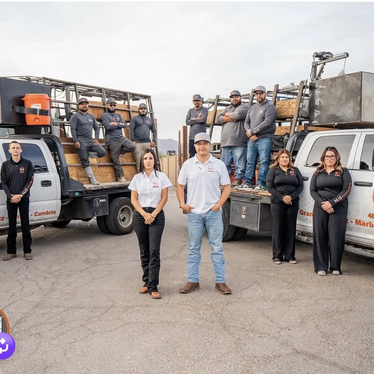 The MAJ Countertops crew standing with their work trucks and slab racks